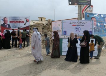 Iraqi people cast their vote at a polling station on May 12.