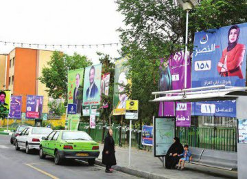 Campaign posters in a street in the predominantly Iraqi district of Dolatabad in downtown Tehran show candidates running in the May 12 parliamentary elections.