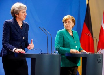 British Prime Minister Theresa May (L) and German Chancellor Angela Merkel attend a news conference after talks in Berlin on Feb. 16. 