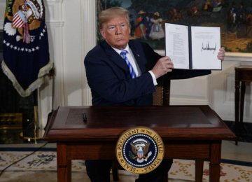 President Donald Trump signs a presidential memorandum on the Iran nuclear deal on May 8.  