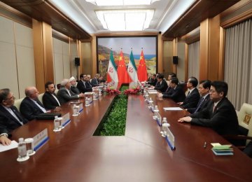 Top-level Iranian and Chinese officials confer as part of meetings that led to the signing of four major MoUs in Qingdao.