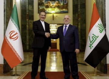 Iran’s First Vice President Es’haq Jahangiri (L) shakes hands with Iraqi President Fuad Masum in Baghdad on March 8.