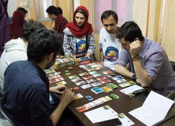 A group of young gamers play at a center in Tehran on the International Tabletop Day in 2017.
