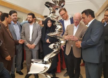 Tony Cragg (2nd R) explains about one of his sculptures in San’ati Museum of Contemporary Art in Kerman.