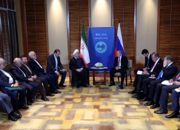 President Hassan Rouhani meets with Russian President Vladimir Putin on the sidelines of the Shanghai Cooperation Organisation (SCO) Summit in Qingdao on June 9.