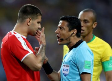 Alireza Faghani talks to Serbia’s Aleksandar Mitrovic during the Wednesday Group B match between Brazil and Serbia.