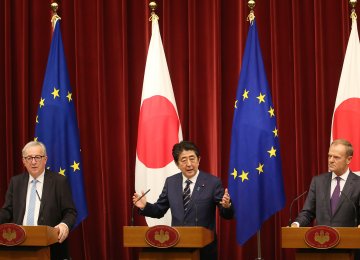 Japanese Prime Minister Shinzo Abe (C) speaks as European Commission President Jean-Claude Juncker (L) and European Council President Donald Tusk listen during  a joint press conference at Abe’s official residence in Tokyo on July 17.