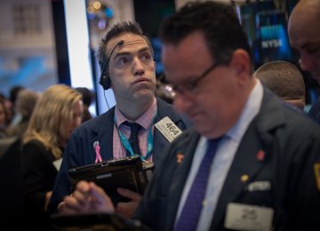 A trader works on the floor at the closing bell of the Dow Jones at the New York Stock Exchange.