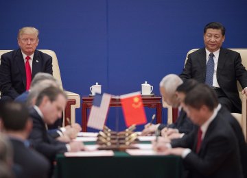 US President Donald Trump (L) and China’s President Xi Jinping attend a business leaders event inside the Great Hall of the People in Beijing on Nov. 9.