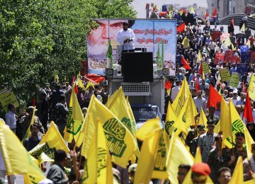 Marchers in Tehran take to the streets on  June 23 to mark International Quds Day. 