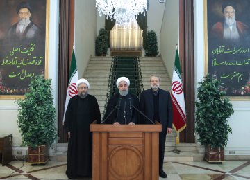 President Hassan Rouhani is flanked by Majlis Speaker Ali Larijani (R) and Judiciary Chief Sadeq Amoli Larijani in Tehran on Nov. 11.