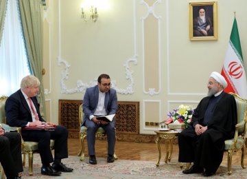British Foreign Secretary Boris Johnson (L) meets President Hassan Rouhani in Tehran on Dec. 10.