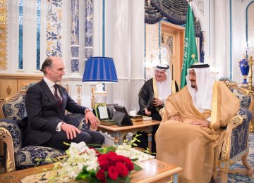 Conservative MP Leo Docherty (L) has been reported to the UK parliamentary standards watchdog  over his meeting with Saudi King Salman.