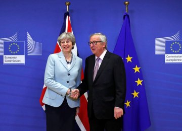 Prime Minister Theresa May is welcomed by European Commission President Jean-Claude Juncker in Belgium, December 8.