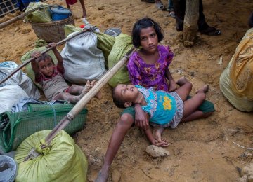 A Rohingya girl, who spent four days in the open after crossing over from Myanmar into Bangladesh, holds her sister at Kutupalong refugee camp, Bangladesh on Oct. 19.