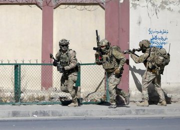 Afghan and foreign security forces arrive at the site  of the attack in Kabul, Afghanistan, November 7.