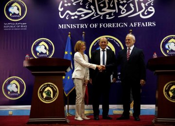 French Defense Minister Florence Parly (L) shakes hands with Iraqi Foreign Minister Ibrahim al-Jaafari with French Foreign Minister Jean-Yves Le Drian present during a joint news conference in Baghdad on August 26.