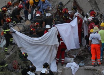 Rescuers work amid the rubble of a building that collapsed in Torre Annunziata, near Naples, southern Italy, on July 7.