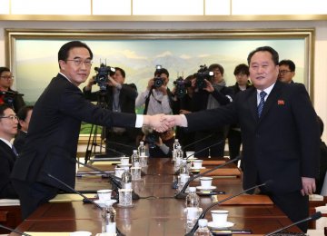 Head of the North Korean delegation, Ri Son Gwon (R), shakes hands with his South Korean counterpart, Cho Myoung-gyon, during their meeting at the truce village of Panmunjom on January 9.