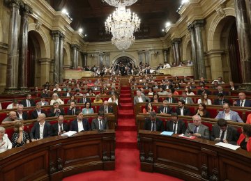 Carles Puigdemont (C, front row) attends a session  of the Catalonian regional Parliament in Barcelona,  Spain, September 6, 2017.