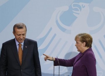 German Chancellor Angela Merkel speaks to Turkish Prime Minister Tayyip Erdogan as they address the media after meeting in the Chancellery in Berlin, in April 2016.