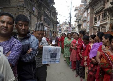 Nepalese stand in a queue to cast their votes at a polling station during the local election in Bhaktapur, Nepal, on May 14.