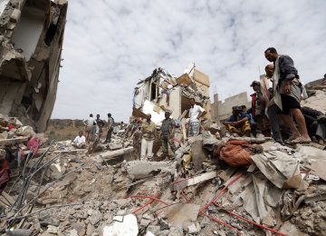 Yemenis search under the rubble of a house destroyed in a Saudi-led airstrike in the capital Sanaa on August 25.
