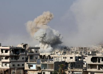 Smoke rises after shelling on a militant-held area of Deraa, Syria, on June 4.