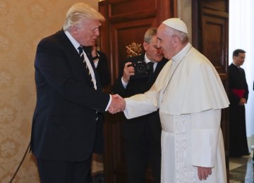 Donald Trump (L) shakes hand with Pope Francis  at Vatican City on May 24.  