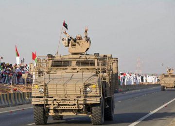 A member of the United Arab Emirates armed forces gestures to the crowd as the first batch of UAE military personnel returns from Yemen in Abu Dhabi, November 7, 2015.