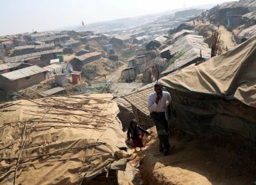 Rohingya refugees walk along the Kutupalong refugee camp in Cox’s Bazar, Bangladesh, on January 21.