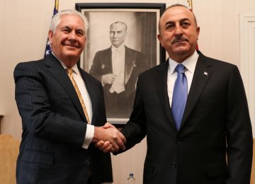 US Secretary of State Rex Tillerson (L) shakes hands with his Turkish counterpart, Mevlut Cavusoglu, in Ankara on Feb. 16.