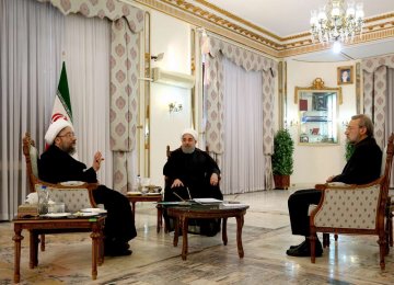 President Hassan Rouhani is flanked by Judiciary Chief Sadeq Amoli Larijani (L) and Parliament Speaker Ali Larijani in Tehran on Nov. 11.