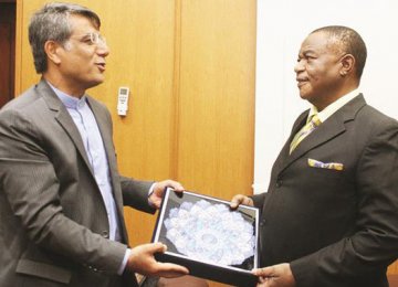 Acting President of Zimbabwe Constantino Chiwenga (R) receives a gift from Iranian Ambassador to Zimbabwe Ahmad Erfanian during a courtesy call in Harare on April 5.