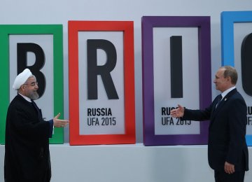  President Hassan Rouhani (L) meets Russian President Vladimir Putin at 2015 BRICS summit in Russia.