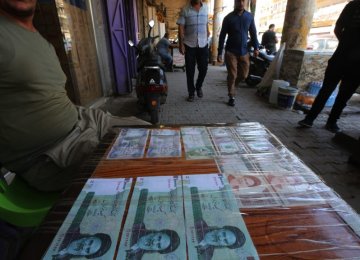 An Iraqi peddler displays Iranian currency for sale in the capital Baghdad on Aug. 9. 