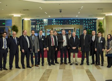 Dawood Nazirizadeh (1st L), Andreas Schmitt (3rd L) and Dr. Joe Weingarten (C) pose alongside other members of  Rhineland-Palatinate business delegation in Tehran on Feb. 5.