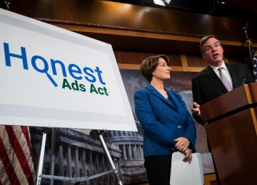 Democratic Senators Amy Klobuchar (L) and Mark Warner introduced the Honest Ads Act, in Washington, D.C. on Oct. 19.