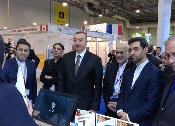 Azerbaijani President Ilham Aliyev (C) and Iran’s Telecoms Minister Mohammad Javad Azari Jahromi (1st R) visited Asan Bar’s booth at Bakutel 2017.