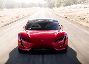 Tesla Roadster Speeds in Front of Electric Truck 