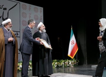 Silvia Balatti from University of Kiel, Germany,(R) receives her award from President Hassan Rouhani (C)  and Culture Minister Seyyed Abbas Salehi.