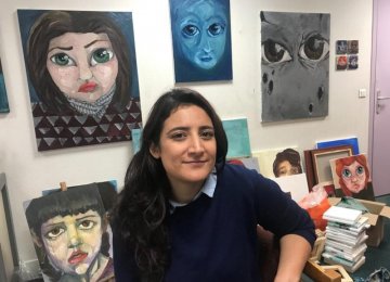 Syrian artist Lina Aljijakli with her paintings in the Atelier for Artists in Exile in Paris