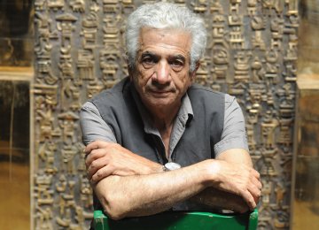 Parviz Tanavoli with his bronze sculpture The Wall (Oh Persepolis).