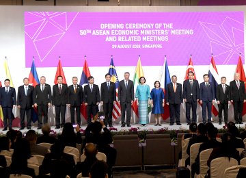 ASEAN members gather for a family photo at the opening of 50th ASEAN Economic Ministers Meeting in Singapore on August 29.