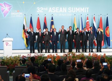 ASEAN leaders pose for a group photograph during the opening of the 32nd ASEAN  Summit in Singapore on Saturday.