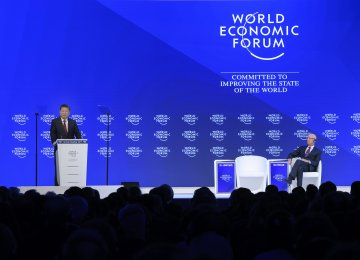 China’s President Xi Jinping (L) delivers a speech on the opening day of the World Economic Forum, on January 17, in Davos. WEF executive chair Klaus Schwab in on the right.