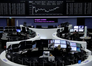 Traders in front of the German share price index, DAX board, at the stock exchange in Frankfurt. 