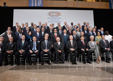 G20 Finance ministers pose for a group photo at the IMF headquarters during the WB/IMF Annual Meetings in Washington, DC, Friday.