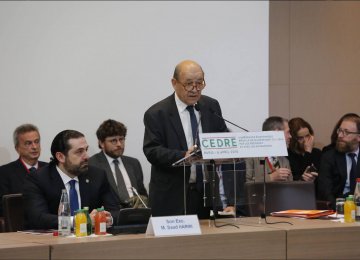 French Foreign Minister Jean-Yves Le Drian addresses CEDRE Conference in Paris on April 6, with Lebanese Prime Minister Saad Hariri on his right. 