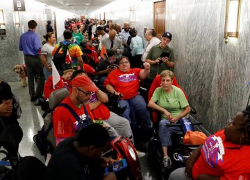Protesters gathered in the Capitol Hill hallway while during a Senate committee hearing on healthcare.